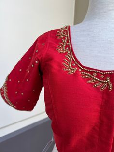 Bright Red Color Raw Silk Readymade Blouse with beautiful Handwork Work in beads and Zircon. Item : Readymade BlouseReady-to-Wear : YesSize : 36 (Can be opened to Size 40)Color : Bright Red Blouse Fabric : Soft Silk Lining : Yes, it is fully lined Padded or Non-Padded : PaddedClosure: Front Closure with hooks.Disclaimer - : -This is a Standard Size blouse. We do not guarantee perfect fit as every body and shape is different. Little or no alteration would be required to get the perfect fit. - Col Elegant Red Blouse Piece With Zari Work, Formal Red Blouse Piece With Pallu, Elegant Festive Tops With Dori Work, Bollywood Style Red Blouse For Wedding, Formal Red Padded Blouse, Festive Red Short Sleeve Tops, Elegant Red Blouse With Zari Work, Formal Red Blouse Piece With Zari Work, Elegant Embroidered Red Blouse Piece