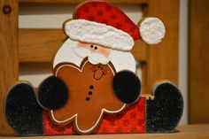 a wooden ginger with a santa hat on