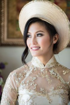 a woman wearing a white hat and dress