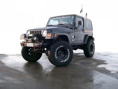 a black jeep parked on top of a parking lot