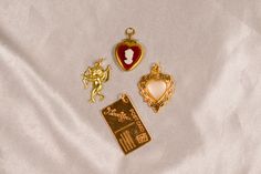 The Lovers Vintage Charm Lot includes: 1 Vintage Red Cameo Heart Locket Charm, 1 Vintage I Love You Postcard Charm, 1 Vintage Pearl Heart Charm, and 1 Vintage Cupid Charm. All charms are brass and may need to be touched up with a jewelry cloth to keep them sparkling! Not to worry I include a jewelry cloth with every order BUILD YOUR OWN CUSTOM CHARM NECKLACE here: https://cloakedinconfidence.etsy.com/listing/1660083621 This charm comes with a gold filled jump ring ready to slide on any chain you might have or to use for jewelry making projects♡ If you need a chain please check out my gold filled everyday paperclip chain: https://www.cloakedinconfidence.co/product-page/large-paperclip-chain This listing is for all brass charms included in the picture. These charms are all light weight and e Vintage Personalized Charm Necklaces For Wedding, Dangling Pendant Charms For Valentine's Day, Personalized Vintage Charm Necklaces For Wedding, Personalized Vintage Charm Necklace For Wedding, Valentine's Day Dangling Charms Pendant, Valentine's Day Pendant Charms With Dangling Details, Vintage Heart Charm Necklace For Keepsake, Vintage Heart Pendant Charm Necklace, Vintage Collectible Charm Necklaces