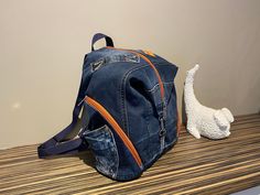 "From daily travels to commuting to work or going to school, this backpack is a perfect way to go. A large compartment, that is secured by a zipper offers room for any items. There are 2 smaller exterior pockets that help keep small essentials stored. Product Size: Length 30cm (12\"), Height 33cm (13\")." Cheap Denim School Backpack, Cheap Denim Blue Backpack, Jeans Backpack, Jean Backpack, Denim Backpack, Recycled Jeans, Going To School, Commute To Work, No Waste