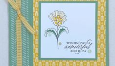 a birthday card with a yellow and green ribbon around it's edge that says, wishing you a wonderful birthday