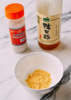 the ingredients to make this dish are in small bowls on the counter top, along with an orange and white jar