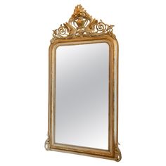 an ornate gold framed mirror against a white background