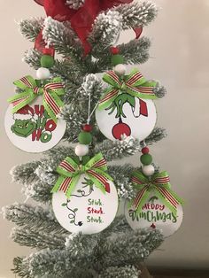 a christmas tree with ornaments hanging from it's branches and decorations on the top