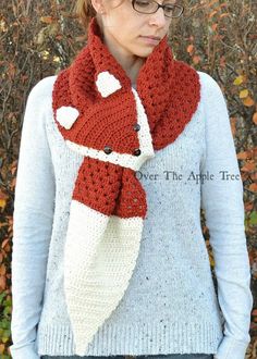 a woman wearing a red and white knitted scarf