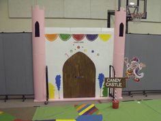 a candy castle is set up in the middle of a gym floor for kids to play