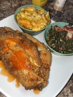 some food is sitting on a white plate with orange sauce and other foods in bowls