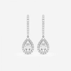 a pair of white gold earrings with pear shaped diamonds on the top and bottom, set in