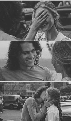 black and white photo of two people kissing each other in front of a city street