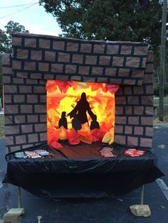 an outdoor display made out of paper and cardboard with a silhouette of a man holding a child