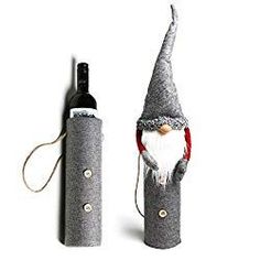 a wine bottle with a gnome's head on it next to a cork holder