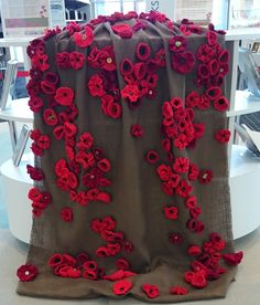 a table topped with red flowers on top of it