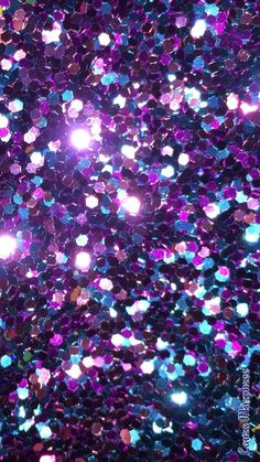 purple and blue glitter sparkles in the air with light shining on it's surface