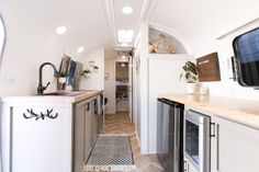 a narrow galley kitchen and dining area in a mobile home