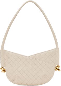 Intrecciato-woven grained lambskin shoulder bag in off-white. · Fixed shoulder strap · Knotted hardware at sides · Zip closure · Suede lining · H6 x W9.75 x D1.5 · Total height: H15.5 Supplier color: Sea salt/Brass Luxury Cream Shoulder Bag With Intrecciato Weave, Luxury Cream Intrecciato Shoulder Bag, Luxury Cream Shoulder Bag With Woven Leather, Luxury Cream Woven Leather Shoulder Bag, Formal Beige Shoulder Bag With Intrecciato Weave, Woven Design, Sea Salt, Bottega Veneta, Bags Women