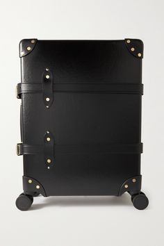 Globe-Trotter's 'Centenary' collection marks 100 years of the brand's most iconic luggage. This carry-on suitcase is made from the brand's patented vulcanized fiberboard that's lightweight but ultra-durable, and finished with supple leather accents at the corners. There's space inside for two to three days' worth of clothes and cosmetics. Carbon steel locks ensure peace of mind when travelling. Luxury Rectangular Luggage With Leather Lining, Luxury Black Cases With Luggage Sleeve, Classic Travel Cases With Leather Trim, Luxury Travel Briefcase With Brass Hardware, Classic Black Luggage With Leather Trim, Travel Globe, Carry On Suitcase, 100th Anniversary, Leather Accents