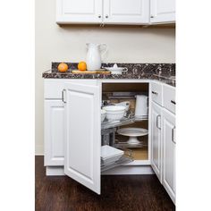 an open cabinet in the corner of a kitchen