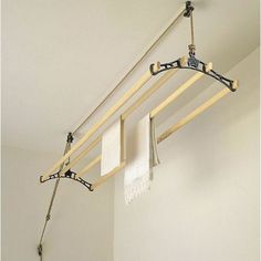 a bathroom with a sink, mirror and towel rack hanging on the wall above it