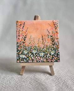 an easel with a painting on top of it