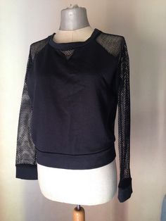 "80s vintage black sweater featuring net sleeves and boxy fit Boat neckline with a mesh triangle and lots of coolness Ready and waiting to pair up with a pair of baggy pants and your old vans loafers, this bold mesh blouse is ready to make one gal feel the ultimate 80's look! ‼️Be aware --- only one is available ------- 🌀MEASUREMENTS: (Garment is Lying flat) *BUST (armpit to armpit ) : 49.5 cm / 19.5\" *WAIST (waistband): 43 cm / 17\" *LENGTH - Measured from shoulder to hem: 52 cm/ 20.5\" Made Vans Loafers, Net Sleeves, Cupro Fabric, 80s Look, Mesh Blouse, Fitted Blouses, Baggy Pants, Baggy Pant, Silver Shoes