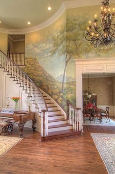 a staircase leading up to a large painting on the wall