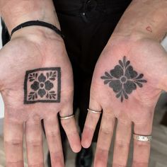 two people with matching tattoos on their hands