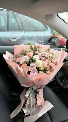 a bouquet of flowers sitting in the back seat of a car