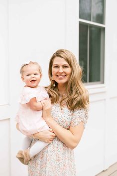 a woman holding a baby in her arms