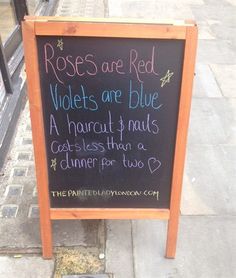 a sign on the sidewalk that says roses are red violets are blue and a handwritten poem is written in cursive writing