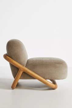 an upholstered lounge chair with wooden legs