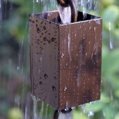 an umbrella is hanging in the rain with it's brown box attached to it