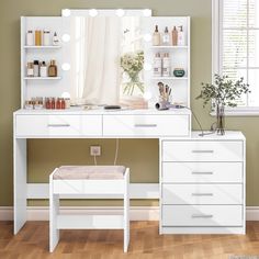 a white dressing table with lights on it