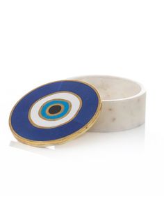 a white and blue ring with an evil eye on the inside, sitting in front of a white background