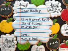 decorated cookies with writing on them are displayed