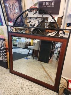 a large mirror sitting on top of a table