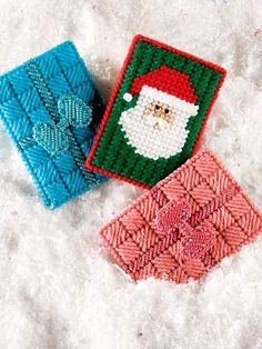 two crocheted coasters sitting on top of snow next to eachother