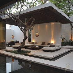 an outdoor living area with couches and trees