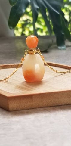 Peach Jade Perfume Bottle Necklace, Perfume, Bottle, Gemstone Necklace, Perfume Bottle, Boho Necklace, Jade Necklace, Crystal, Gold Necklace What a gorgeous color, amiright?! This piece is 19 inches long with stainless steel gold chain and peach crystals. The top of the bottle is removable and works for your fave essential oils, perfume, or potions. 3 shades left...light, medium, and dark. While jade meaning is rooted in calm wisdom, healing and protection, there is a belief that each jade color Elegant Amber Crystal Necklace For Gift, Elegant Orange Crystal Necklace For Gift, Elegant Orange Crystal Necklace As A Gift, Elegant Orange Necklace For Healing, Peach Crystals, Essential Oils Perfume, Jade Meaning, Jade Color, Bottle Necklace