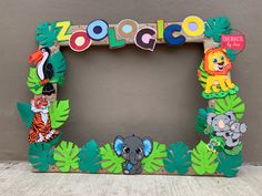 a wooden frame decorated with different animals and letters that spell out the word zoologico