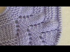 a close up of a purple knitted blanket