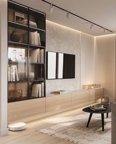 a living room filled with furniture and a flat screen tv mounted on a wall next to a window