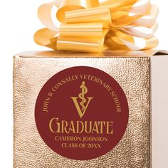 a gold gift box with a ribbon on top that says graduate class of 20x