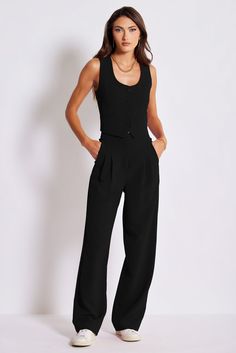 The Madison Vest, a feminine take on a menswear classic with a low scoopneck and front button closure. This timeless silhouette is a great transition piece—wear solo now and layer over shirts or sweaters later. Pair it with its coordinating Madison Pleat Pant for a monochromatic look. K4EVS2631-BLK Business Casual Summer, Maxi Jumpsuit, The Madison, Summer Style Casual, Pleated Pants, Black Xs, Poplin Shirt, Fashion Essentials, Sweater Shop