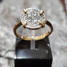 This ring is both simple and elegant at the same time. The coin itself is made from the silver bars recovered from the Atocha and comes with a certificate stating that. I use a very simple band of sterling silver with a 14kt gold overlay to give more prominence to the coin. It has a very beautiful and delicate look to it in person. I also sign my name on the back so you know you are getting a JackSpirit original design. Gold Coin-shaped Engraved Ring, Elegant Engraved Coin Rings, 14k Gold Coin-shaped Rings, Yellow Gold Coin-shaped Hallmarked Rings, 14k Stamped Yellow Gold Coin Ring, Gold Coin-shaped Ring For Anniversary, Gold Coin-shaped Anniversary Ring, 14k Gold Coin Shaped Anniversary Rings, Hammered Wedding Rings