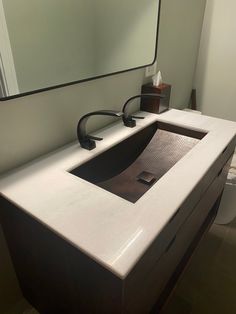 a bathroom sink with a mirror above it