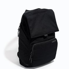 a black backpack sitting on top of a white floor