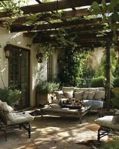 an outdoor living area with couches and chairs