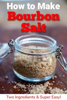 how to make bourbon salt in a glass jar on a wooden table with text overlay that reads, how to make bourbon salt two ingredients & super easy